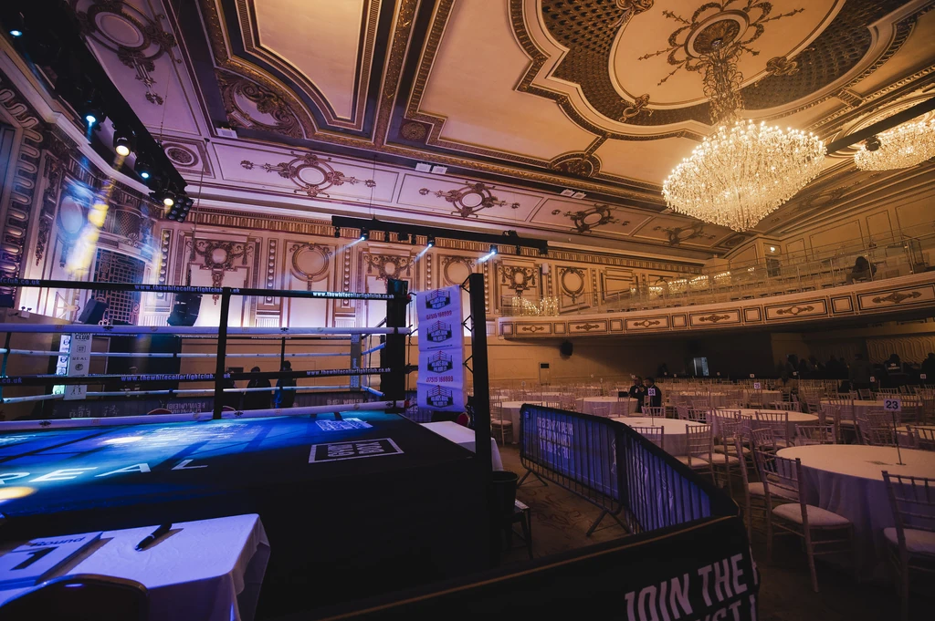 The ring and dinner tables at a past black tie fight night