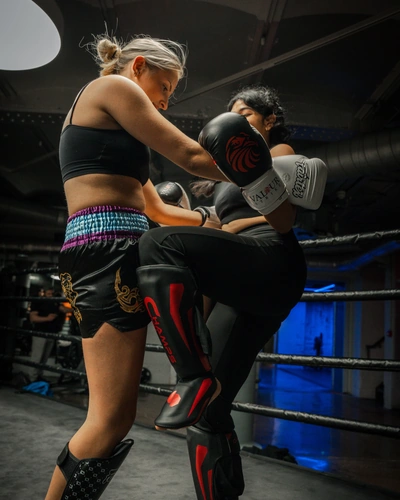 Two women practising knees in the clinch
