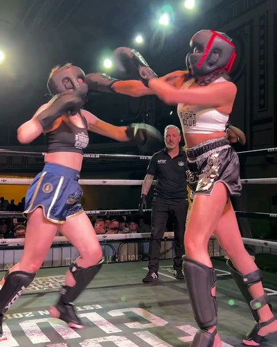 Two women in a Muay Thai bout on fight night