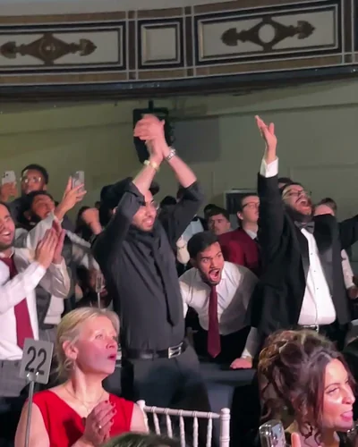 Supporters on their feet cheering on fight night