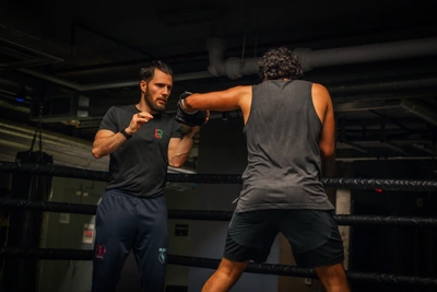 A boxer working with a coach in training