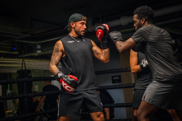 Two fighters training boxing in the ring at Gymbox