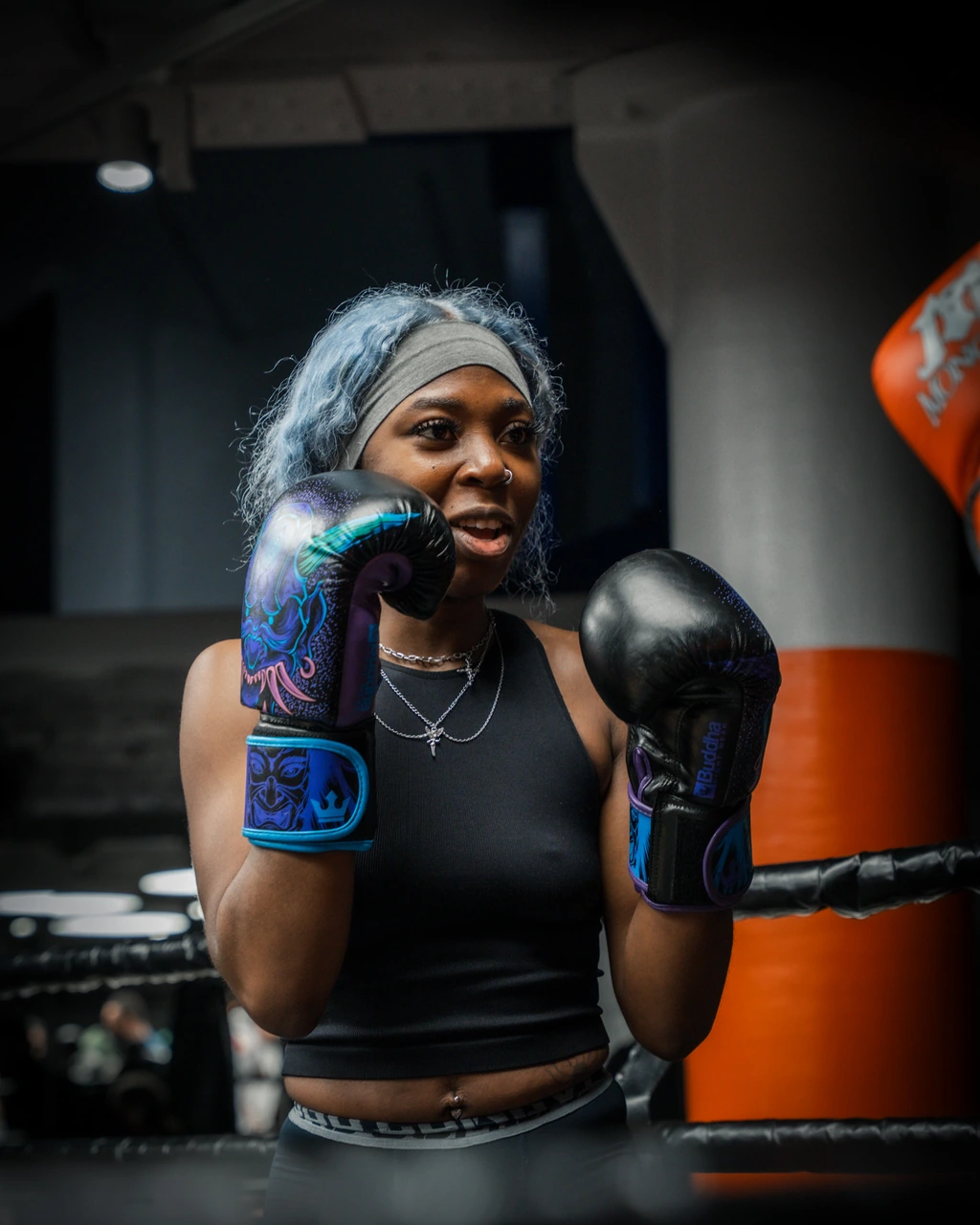 A fighter with silver-blue hair, gloves up, training in the ring during camp