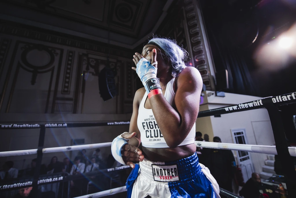 The same fighter in the ring on fight night, overcome with emotion after her bout