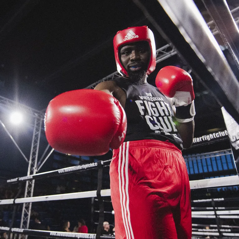 Junior, fight camp manager, throwing a jab in red gloves in the ring