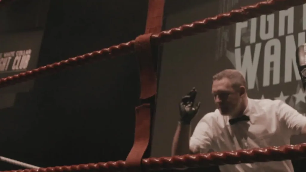 The referee watching from inside the ropes
